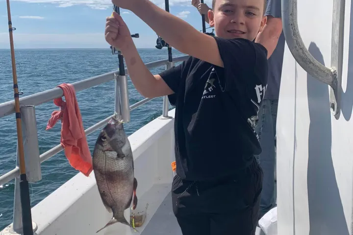 a man holding a fish