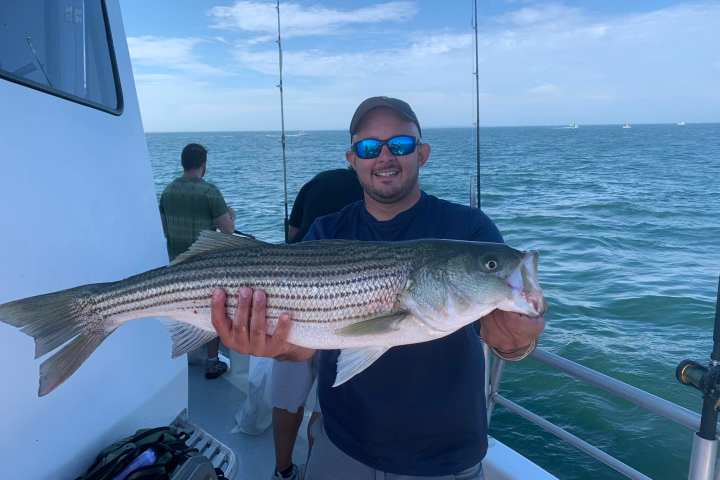 a man holding a fish in the water