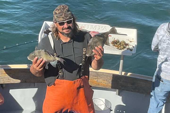 a person holding a fish in the water