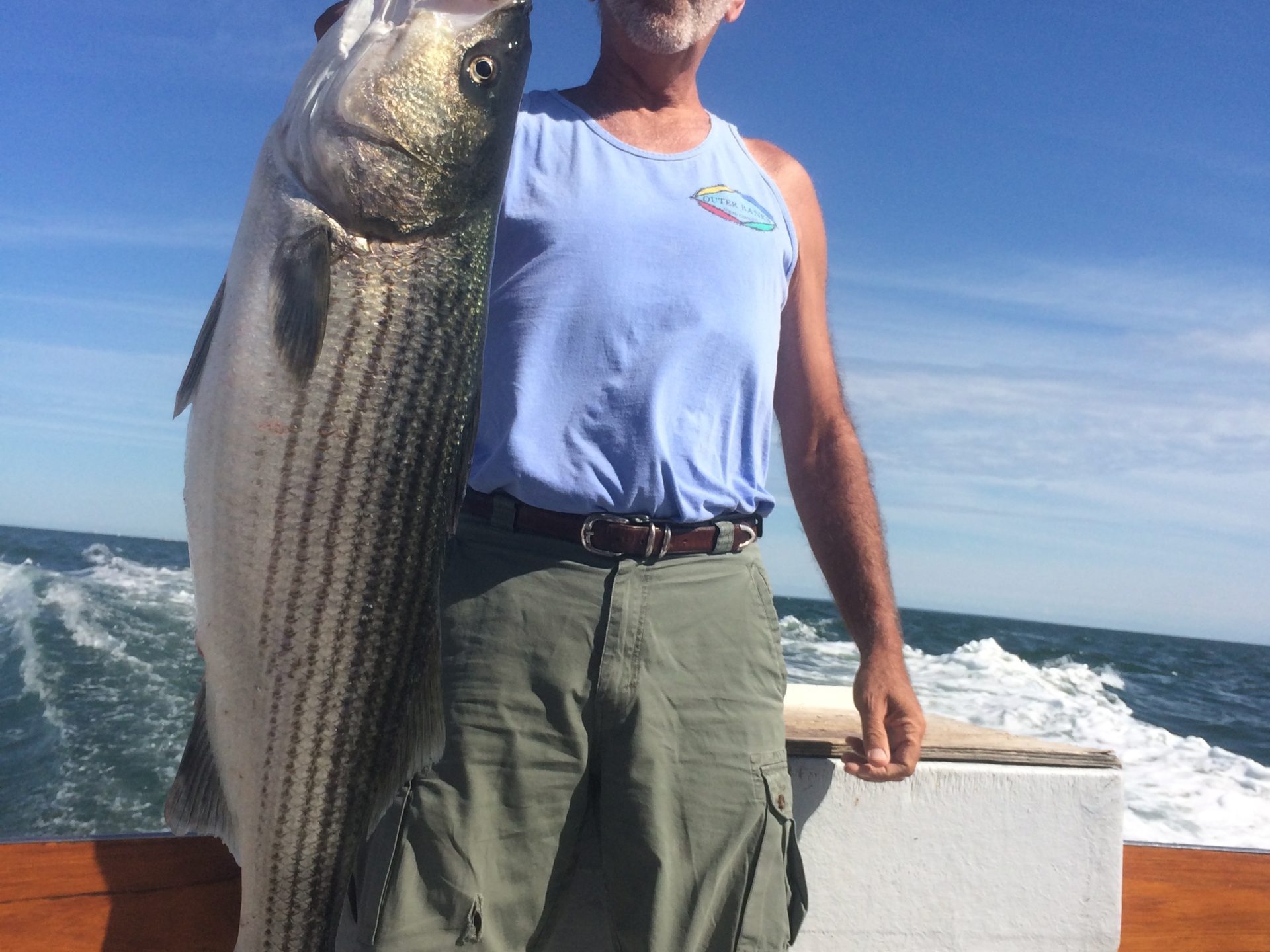 a man holding a fish in the water