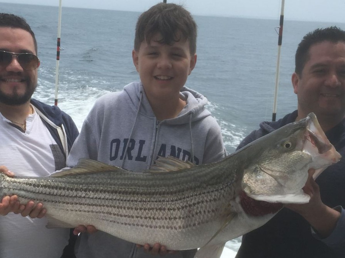 a man holding a fish in the water