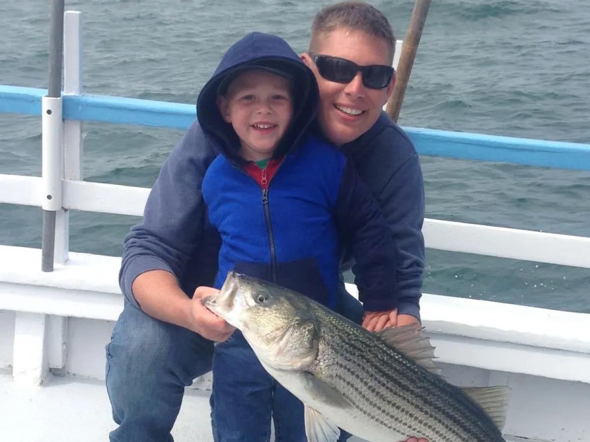 a person holding a fish in the water