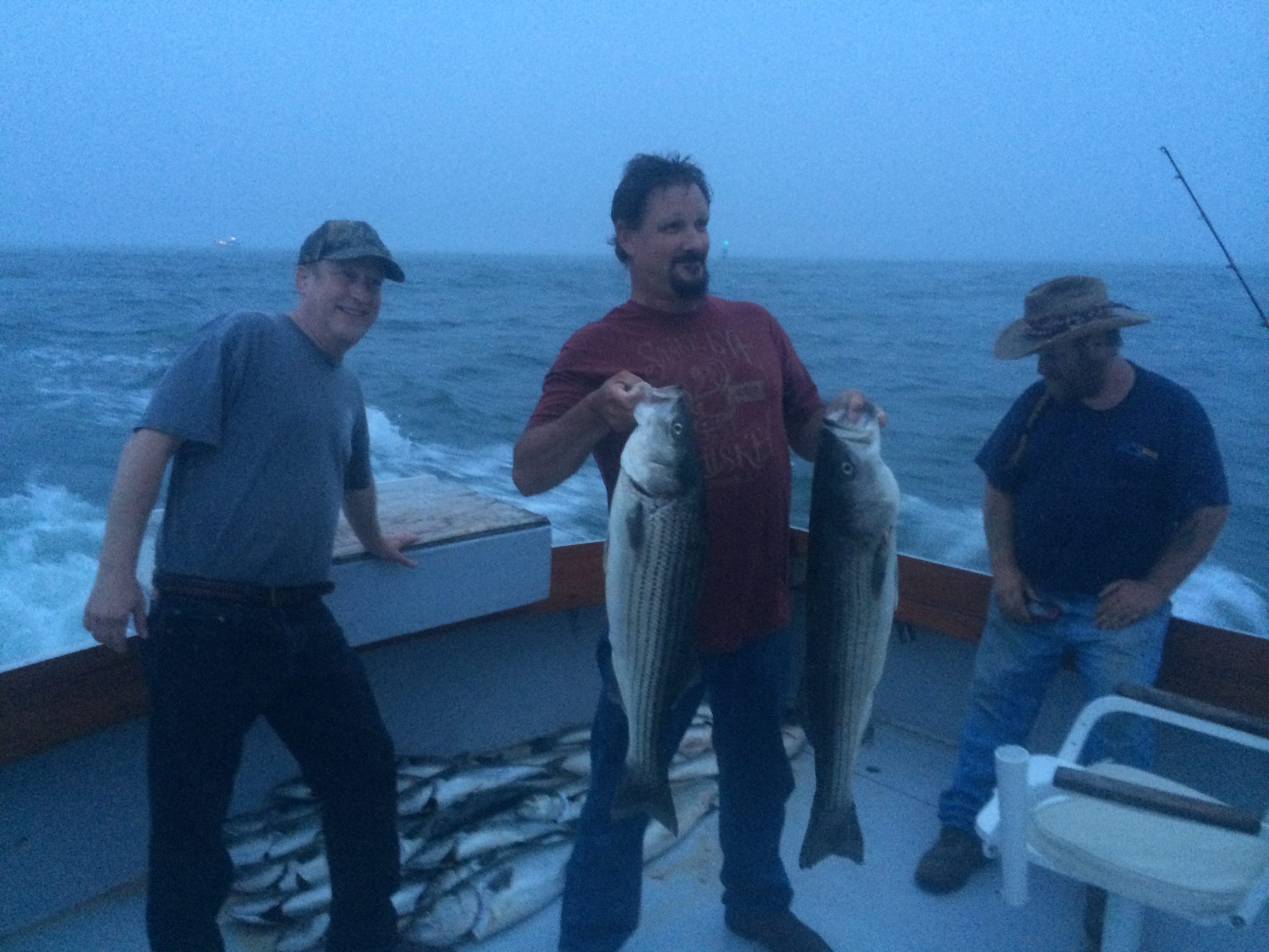 a man holding a fish in the water