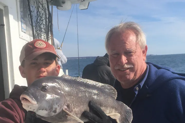 a man holding a fish