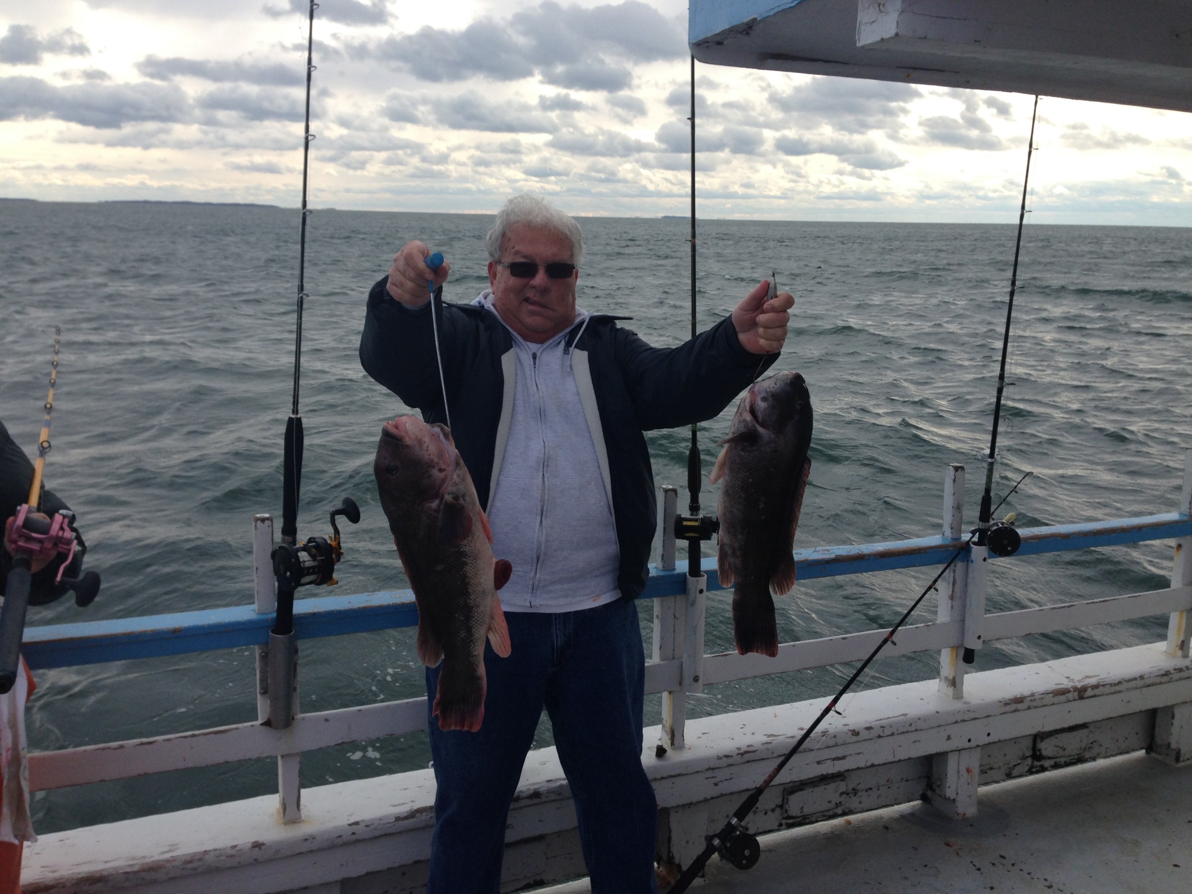 a man standing next to a body of water