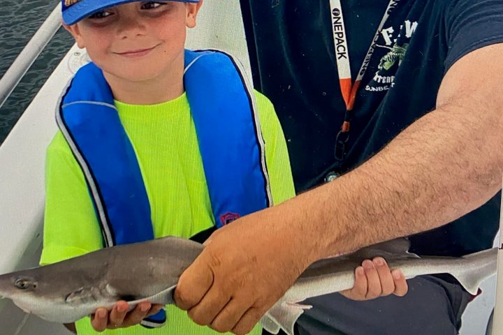 a man holding a fish