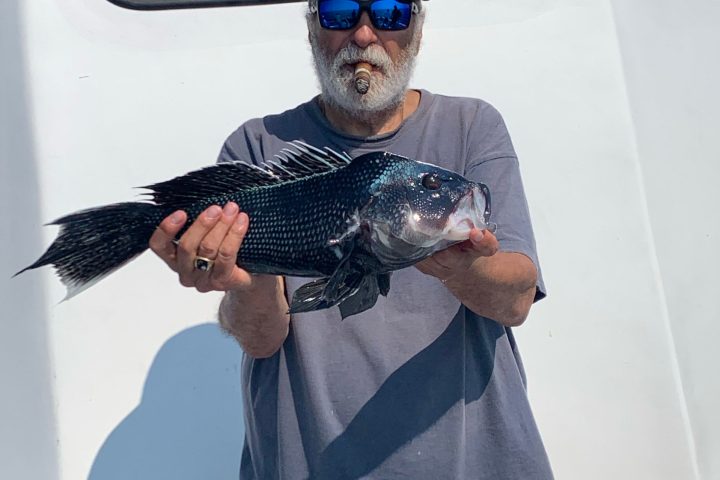 a man wearing sunglasses driving a car