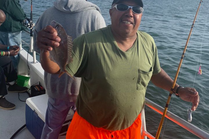a group of people standing on a boat in the water