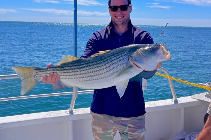 a man holding a fish in the water