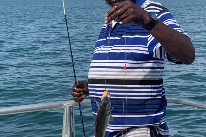 a man standing next to a body of water