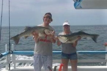 a person holding a fish in the water