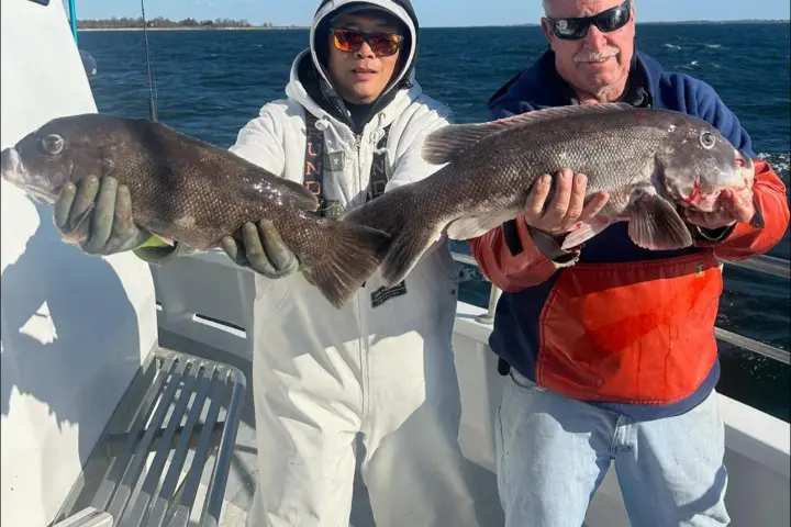 a man holding a fish in the water