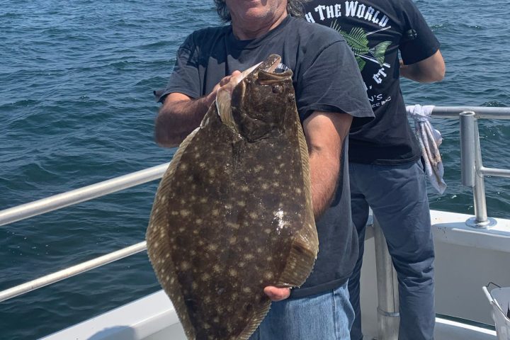 a man holding a fish in the water