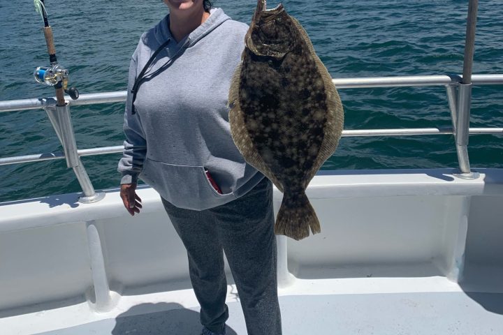 a person standing next to a body of water