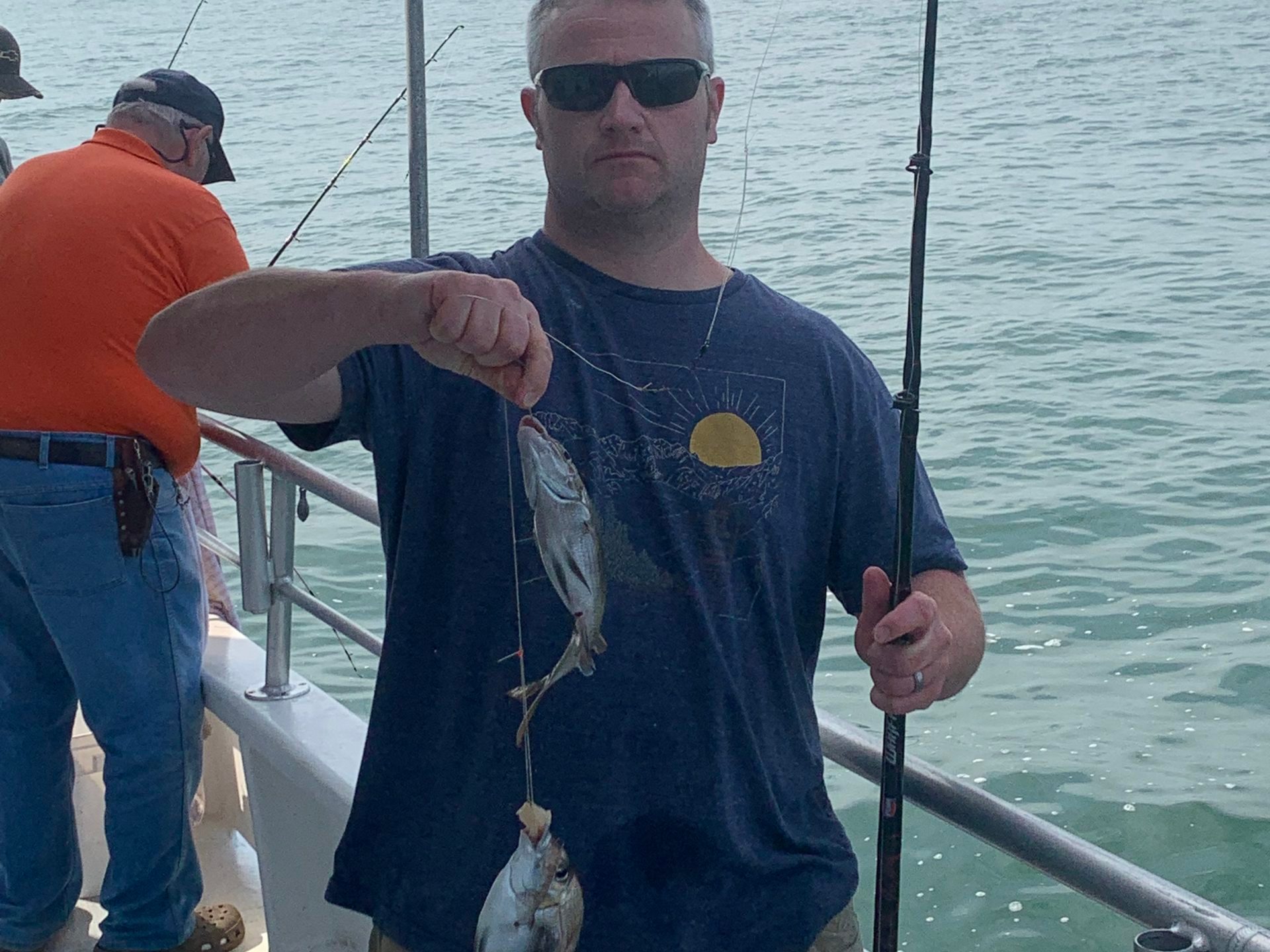 a man holding a fish in the water
