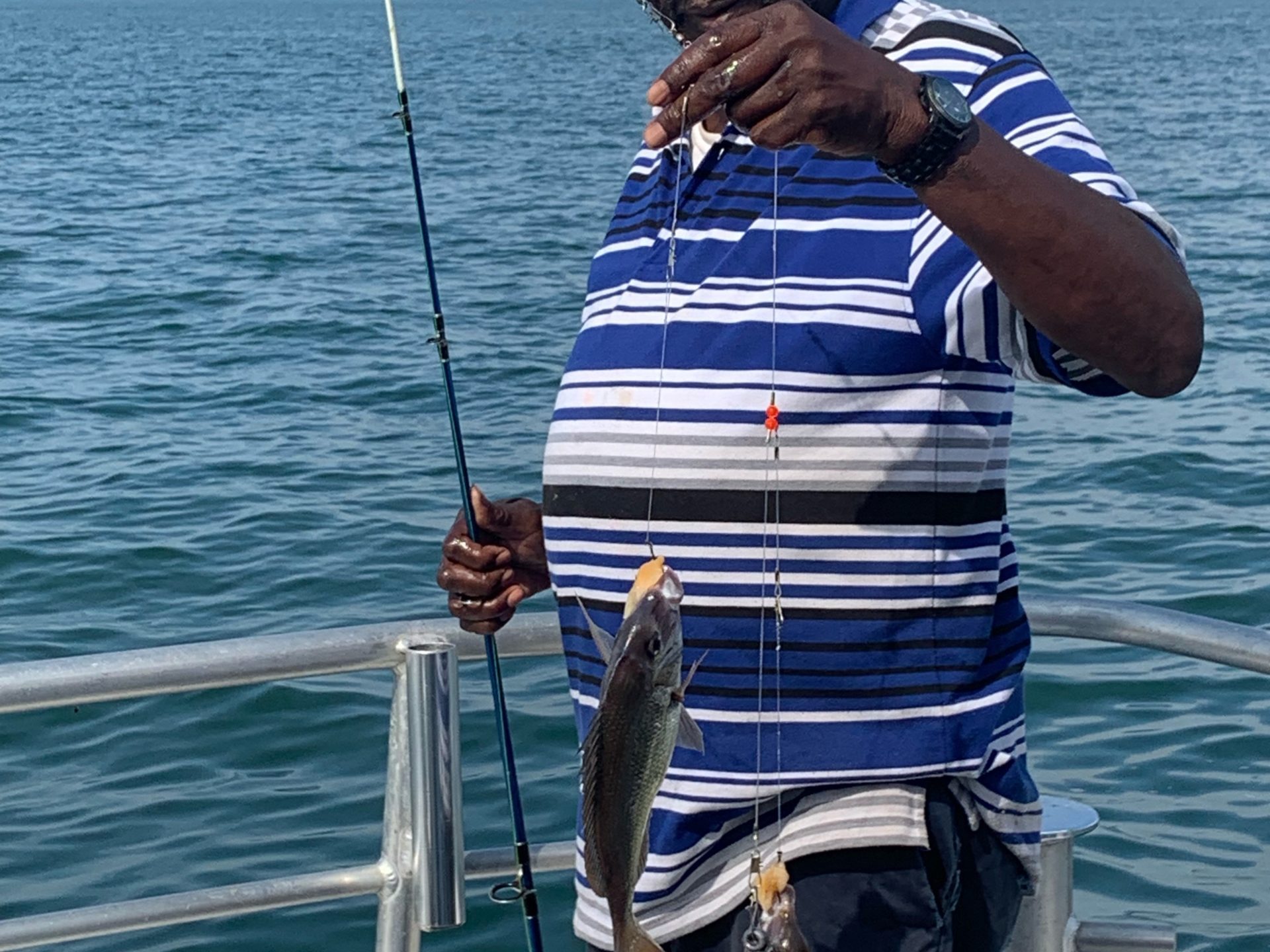 a man standing next to a body of water