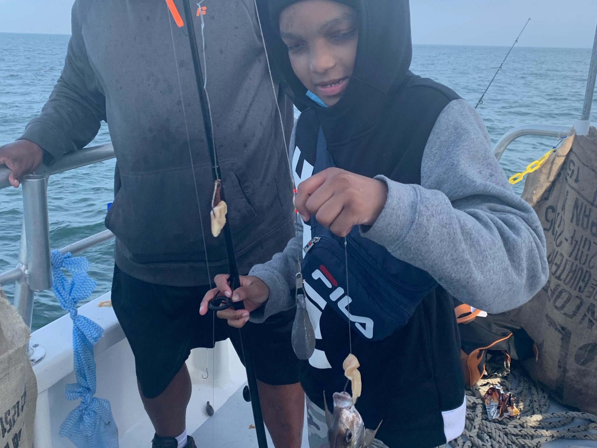 a couple of people standing next to a body of water